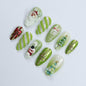 Festive Green Medium Almond Press-On Nails: Adorned with Santa Claus, Snowman Designs - Perfect for Christmas Day or Gift for Her